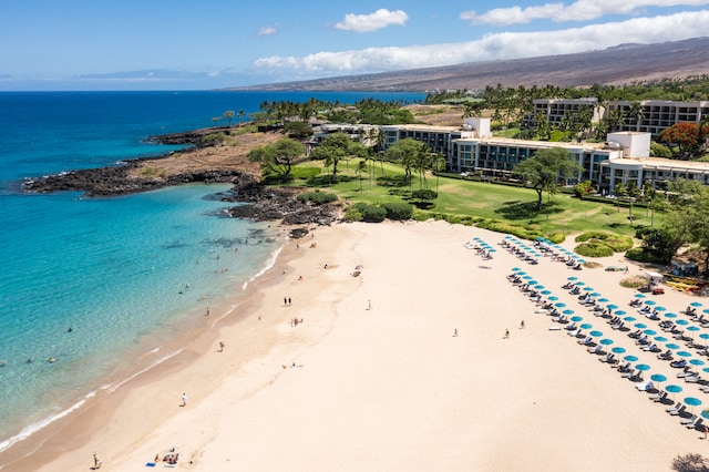 drone / aerial view featuring a view of the beach and a water view