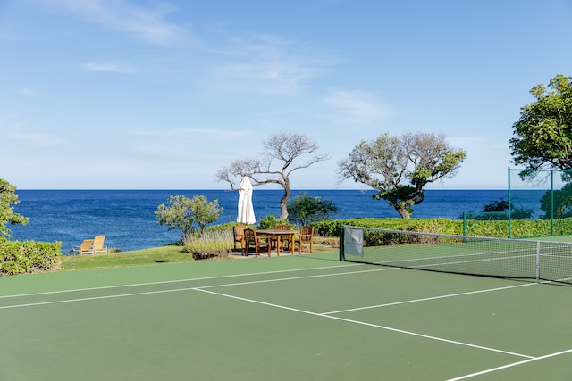 view of sport court with a water view