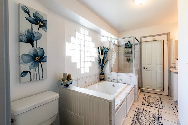 bathroom featuring tile patterned flooring, toilet, and separate shower and tub