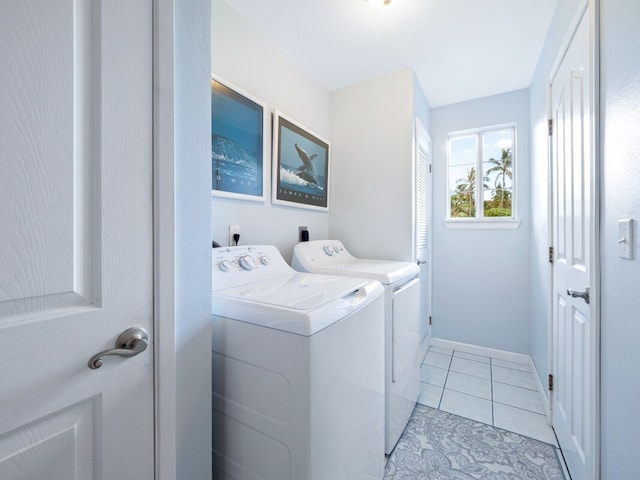 washroom featuring washer and clothes dryer and light tile patterned flooring