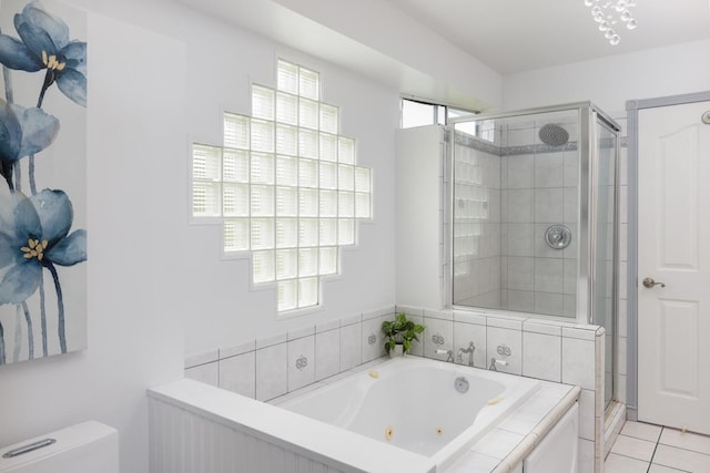 bathroom featuring shower with separate bathtub, a healthy amount of sunlight, tile patterned floors, and toilet