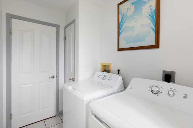 washroom with washer and dryer and light tile patterned floors