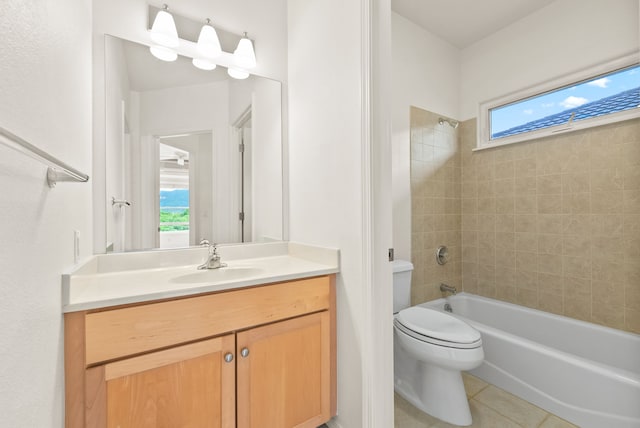 full bathroom featuring toilet, vanity, tile patterned floors, and tiled shower / bath