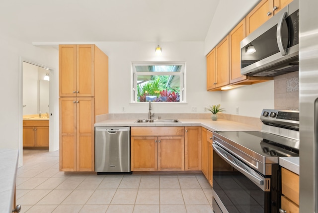 kitchen featuring light tile patterned flooring, sink, and stainless steel appliances