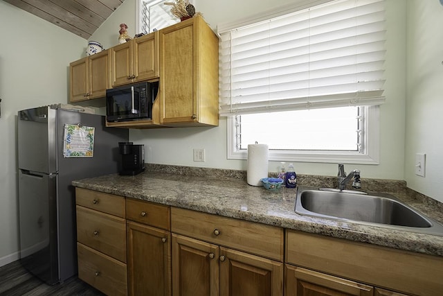 kitchen with wooden ceiling, dark wood-type flooring, sink, vaulted ceiling, and stainless steel fridge