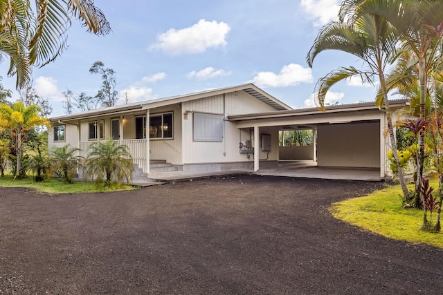 view of front of home with a porch and a carport