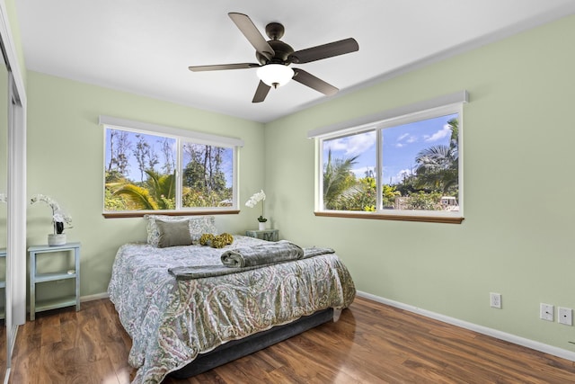 bedroom with ceiling fan and dark hardwood / wood-style flooring