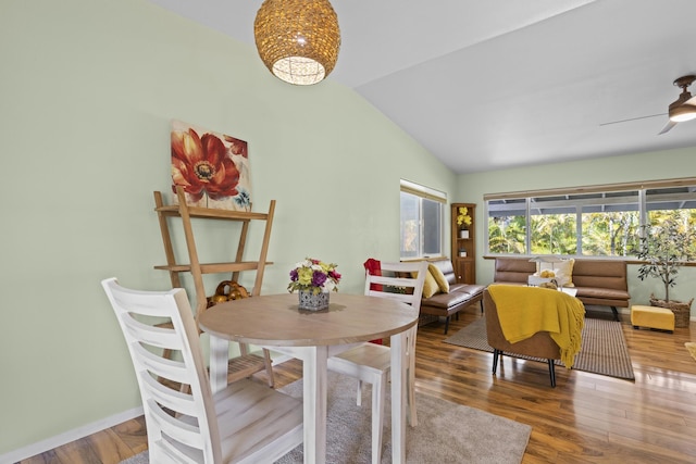 dining room featuring ceiling fan, hardwood / wood-style floors, and lofted ceiling