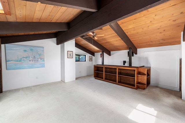 additional living space with carpet, vaulted ceiling with beams, ceiling fan, and wood ceiling