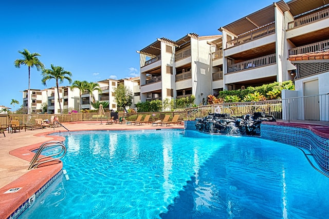 view of swimming pool featuring pool water feature