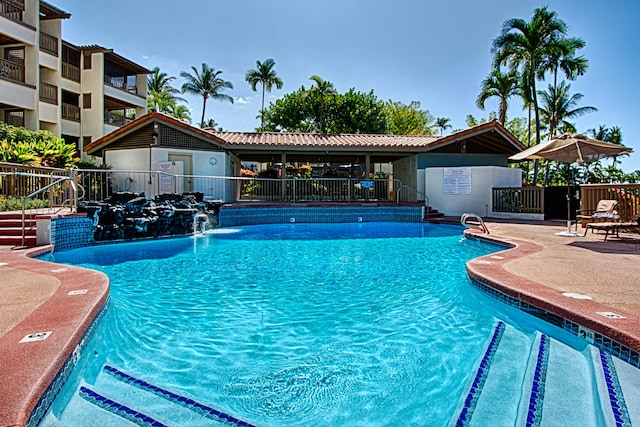 view of pool featuring pool water feature and a patio area