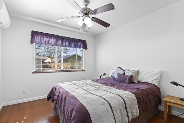 bedroom with a wall unit AC, ceiling fan, and dark hardwood / wood-style flooring