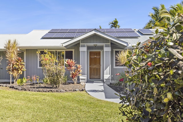 view of front facade with solar panels and a front lawn