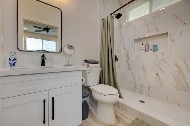 bathroom featuring vanity, curtained shower, and a healthy amount of sunlight