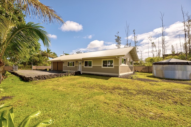 back of property featuring a lawn