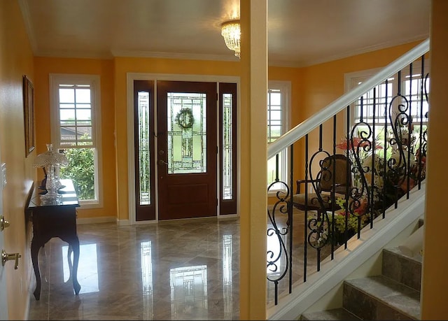 foyer with a notable chandelier and crown molding