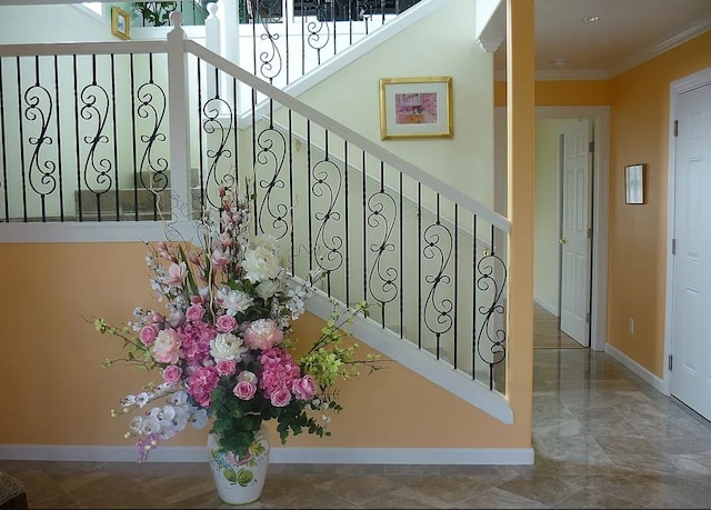 staircase featuring ornamental molding