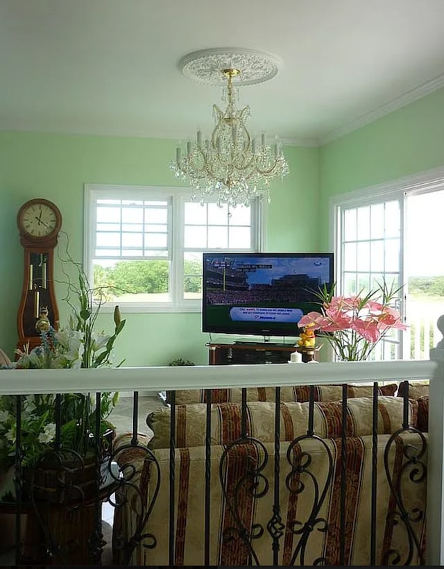 dining space with ornamental molding and a chandelier