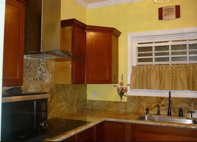 kitchen featuring decorative backsplash, wall chimney exhaust hood, crown molding, sink, and black appliances