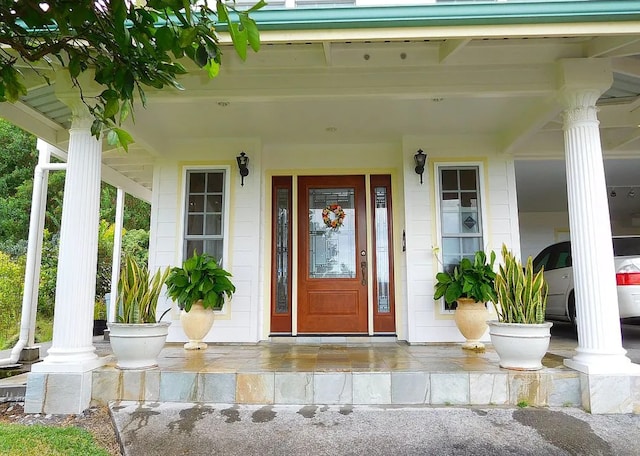 view of exterior entry with a porch