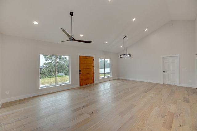 unfurnished living room featuring ceiling fan, light hardwood / wood-style floors, and high vaulted ceiling