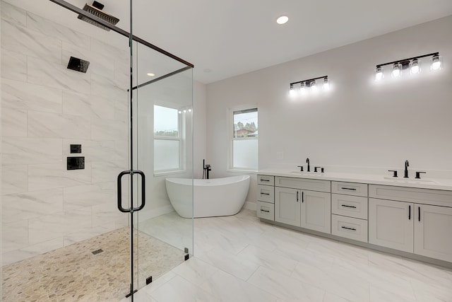 bathroom featuring vanity and shower with separate bathtub