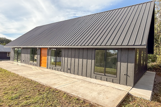 rear view of property featuring a patio and a lawn