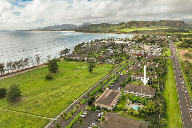 drone / aerial view featuring a water and mountain view