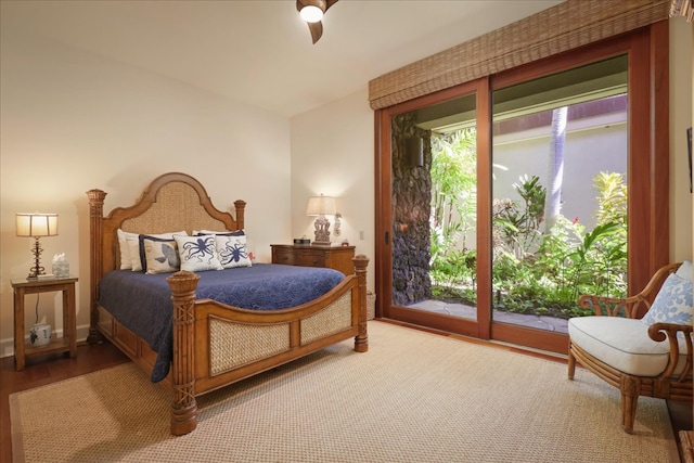 bedroom with ceiling fan, wood-type flooring, and access to outside