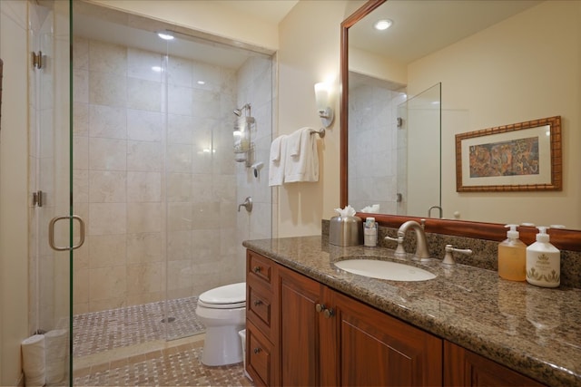 bathroom with vanity, an enclosed shower, and toilet