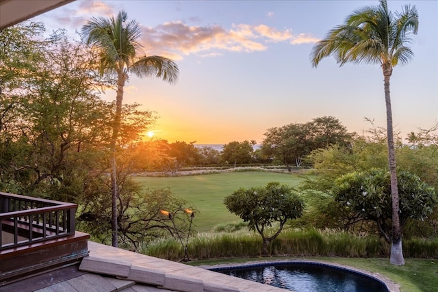 view of pool at dusk