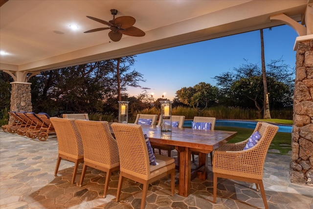 patio terrace at dusk featuring ceiling fan