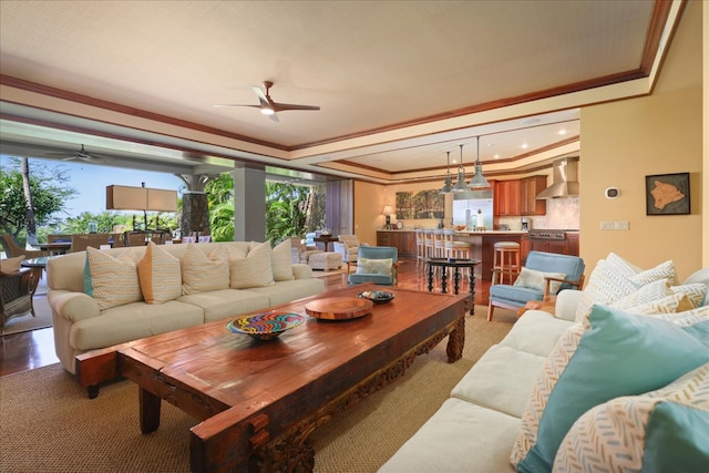 carpeted living room with ceiling fan and ornamental molding