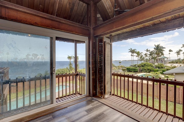 sunroom / solarium with a water view, wood ceiling, and vaulted ceiling