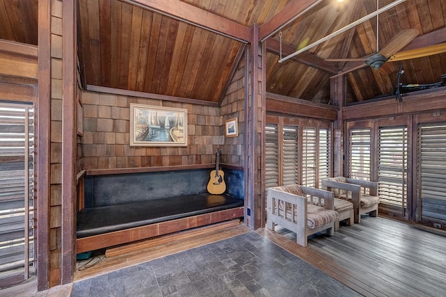 unfurnished room with vaulted ceiling with beams, wood finished floors, wood ceiling, and wooden walls