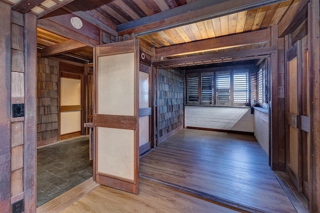 interior space with wooden ceiling, beamed ceiling, and wood finished floors