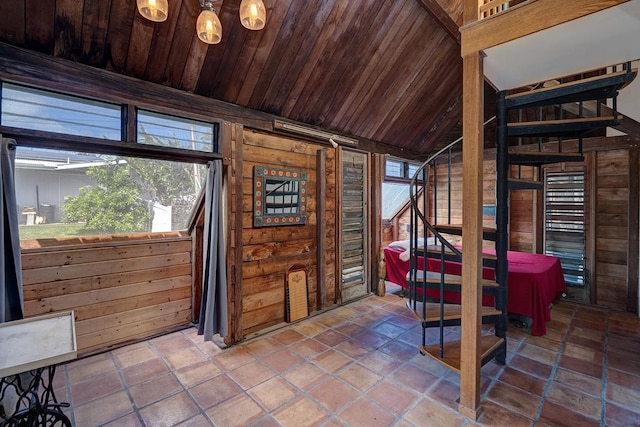 interior space featuring wood ceiling, wooden walls, and vaulted ceiling