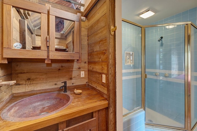 full bath with a shower stall and vanity