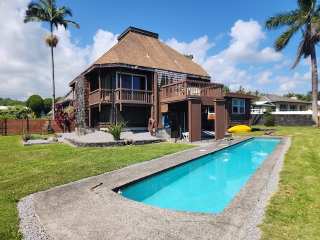 view of swimming pool with a patio, fence, a yard, a wooden deck, and a fenced in pool