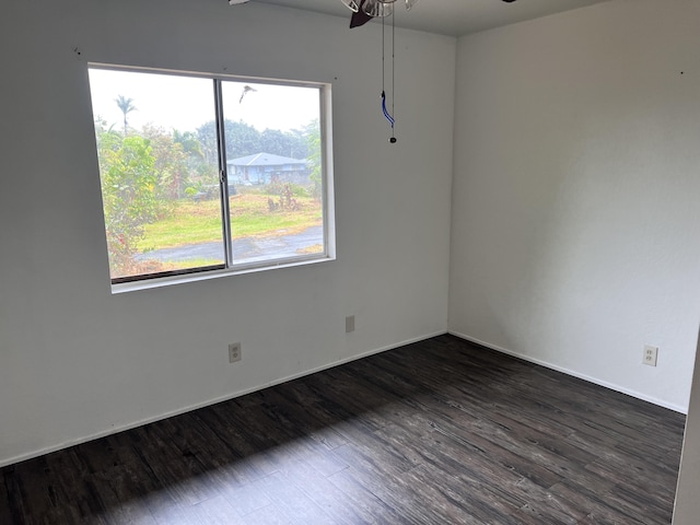 spare room featuring ceiling fan and dark hardwood / wood-style floors