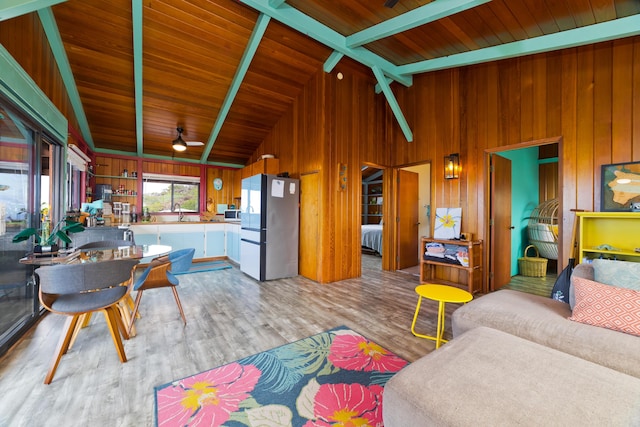 living room with ceiling fan, sink, wooden ceiling, and light wood-type flooring