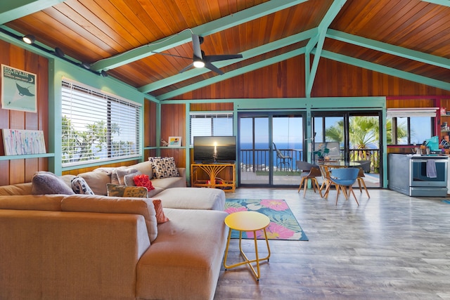 living room featuring hardwood / wood-style floors, wood walls, high vaulted ceiling, ceiling fan, and wood ceiling