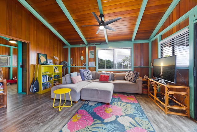 living room with wood ceiling, ceiling fan, wooden walls, hardwood / wood-style floors, and vaulted ceiling with beams