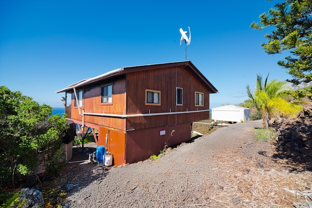 view of side of home featuring an outdoor structure and a garage