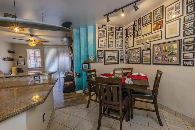 dining space with ceiling fan, light tile patterned floors, and track lighting