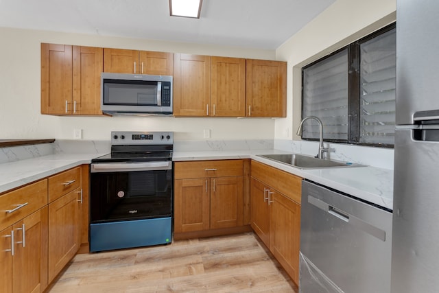 kitchen featuring sink, stainless steel appliances, and light wood-type flooring