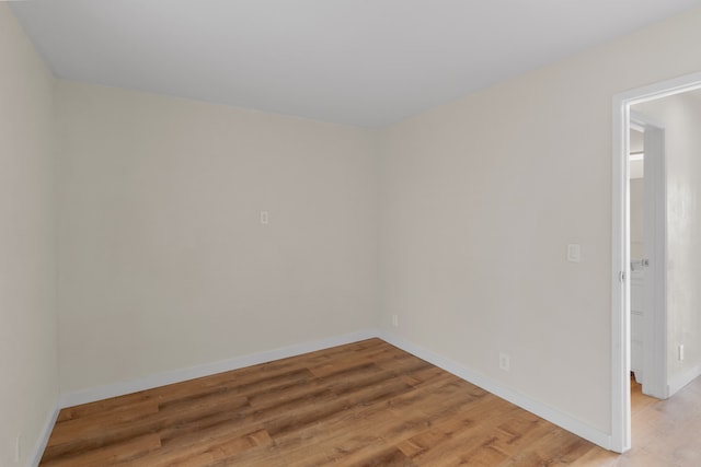 spare room with hardwood / wood-style floors