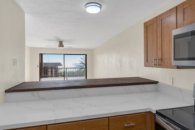 kitchen featuring ceiling fan and electric stove