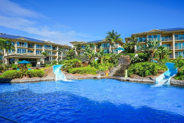 view of pool featuring a water view