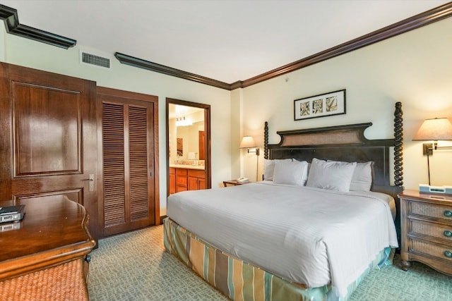 carpeted bedroom with ensuite bathroom and crown molding